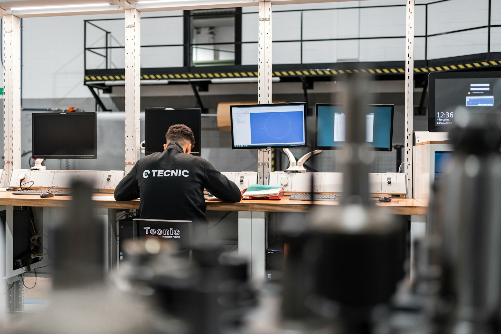 Technical support engineer operating multi-screen setup